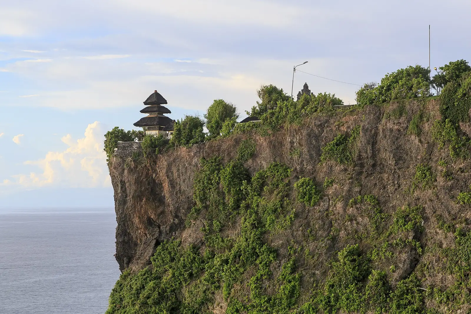 Pura Luhur Uluwatu temple shrine on top of a sheer limestone cliff above the sea in southern Bali